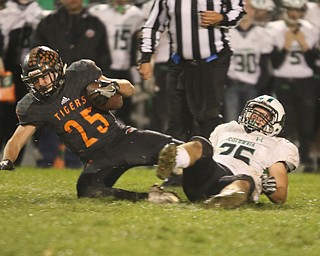  .          ROBERT  K. YOSAY | THE VINDICATOR..#25  Luke Snyder Springfield tries to get extra ards as #25 Columbia Mike Jacobucci  hangs on during third quarter action..Springfield Tigers vs Columbia Raiders..-30-