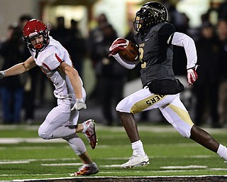 WARREN, OHIO - NOVEMBER 4, 2016: Marlin Richardson #2 of Harding breaks off a big run while Sam Wiglusz #17 of Brecksville-Broadview Heights chases him during the first half of their game Friday night at Warren Harding High School. DAVID DERMER | THE VINDICATOR