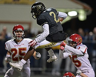 WARREN, OHIO - NOVEMBER 4, 2016: Marlin Richardson #2 of Harding hurdles over Sam Wiglusz #17 of Brecksville-Broadview Heights to score a touchdown during the first half of their game Friday night at Warren Harding High School. DAVID DERMER | THE VINDICATOR..Adrian Asimou #15 and Steve Klaus #25 pictured.