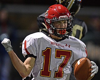 WARREN, OHIO - NOVEMBER 4, 2016: Sam Wiglusz #17 of Brecksville-Broadview Heights celebrates after scoring a touchdown beating Geno Gonzalez #20 of Harding during the first half of their game Friday night at Warren Harding High School. DAVID DERMER | THE VINDICATOR