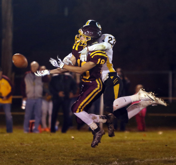             ROBERT  K. YOSAY | THE VINDICATOR..James A Garfield - G-Men  #22 Anthony DeNigris  wraps up SR #18 Marhias Combs causing him not to catch the ball and drew the pass interference call during third quarter action..vs South Range Raiders at South Range Stadium..-30-