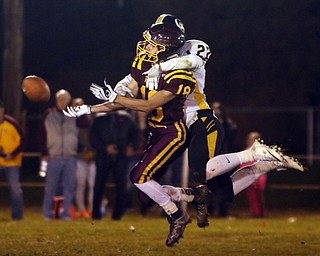             ROBERT  K. YOSAY | THE VINDICATOR..James A Garfield - G-Men  #22 Anthony DeNigris  wraps up SR #18 Marhias Combs causing him not to catch the ball and drew the pass interference call during third quarter action..vs South Range Raiders at South Range Stadium..-30-