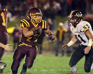             ROBERT  K. YOSAY | THE VINDICATOR..SR #44  Peyton Remish cuts through a hole at the line as Gmen  #51Dane burrows gives case.. James A Garfield - G-Men  vs South Range Raiders at South Range Stadium..-30-
