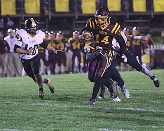             ROBERT  K. YOSAY | THE VINDICATOR..SR #14  Aniello Buzzacco  gets a first downas he drags #81 Gmen Lucas Wordell as #40 Lgan Kissell looks on..James A Garfield - G-Men  vs South Range Raiders at South Range Stadium..-30-
