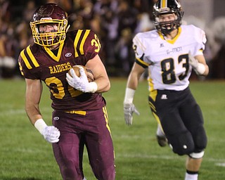             ROBERT  K. YOSAY | THE VINDICATOR..SR #32Nathan Daniszewski scampers down the sideline for a first down and set up the Raiders first as Gmen #83 Jackson Neer gives chase dring first quarter action..u James A Garfield - G-Men  vs South Range Raiders at South Range Stadium..-30-