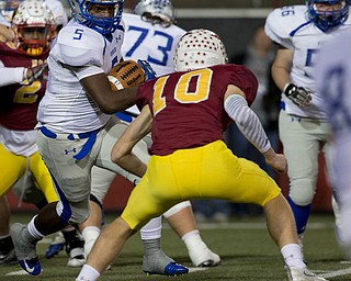 MICHAEL G TAYLOR | THE VINDICATOR- 11-04-16- 1st qtr, Hubbard's #5 Rafael Morales eyes Mooney's #10 Pat Pelini as he picks up 6 yards. OHSAA D4 Football Playoffs Hubbard Eagles vs Cardinal Mooney Cardinals at Stambaugh Stadium, YSU in Youngstown, OH