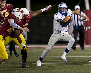 MICHAEL G TAYLOR | THE VINDICATOR- 11-04-16- 2nd qtr, Hubbard's #4 Davion Daniels runs pass the out stretched arm of Mooney's #9  Jaylen Hewlett. OHSAA D4 Football Playoffs Hubbard Eagles vs Cardinal Mooney Cardinals at Stambaugh Stadium, YSU in Youngstown, OH