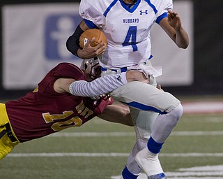 MICHAEL G TAYLOR | THE VINDICATOR- 11-04-16- 2nd qtr, after picking up 16 yards, Hubbard's #4 Davion Daniels is tackled by Mooney's #10 Pat Pelini . OHSAA D4 Football Playoffs Hubbard Eagles vs Cardinal Mooney Cardinals at Stambaugh Stadium, YSU in Youngstown, OH