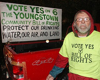 William D. Lewis The Vindicator Randy Younkin, Community Bill of Rights supporter, stands with a sign in his pick up truck outside Box Car Lounge where other Community bill of Rights supporters gathered Tuesday Nov. 8, 2016 after the election.