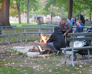 Neighbors | Alexis Bartolomucci.Families surrounded a campfire at Boardman Park on Oct. 14 to roast marshmallows and hot dogs during the Halloween at Boardman Park event.