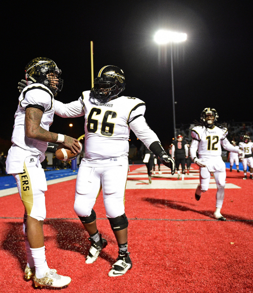 RAVENNA, OHIO - NOVEMBER 11, 2016: Lynn Bowden #1 of Harding is congratulated by teammate Taj Harper #66 after a touchdown during the first half of their playoff game Friday night at Ravenna High School. DAVID DERMER | THE VINDICATOR