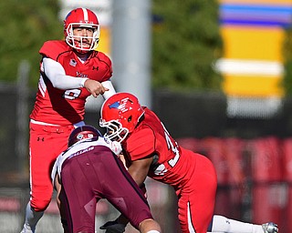 YOUNGSTOWN, OHIO - NOVEMBER 12, 2016: Quarterback Hunter Wells #6 of YSU throws a pass behind the block of Tevin McCaster #37 during the second half of their game Saturday afternoon at Stambaugh Stadium. YSU won 21-14. DAVID DERMER | THE VINDICATOR
