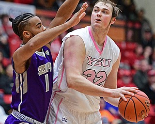 YOUNGSTOWN, OHIO - NOVEMBER 12, 2016: Jorden Kaufman #32 of YSU looks to the basket while being guarded by Josh Williams #1 of Akron during the first half of their game Saturday night the Beeghly Center. DAVID DERMER | THE VINDICATOR