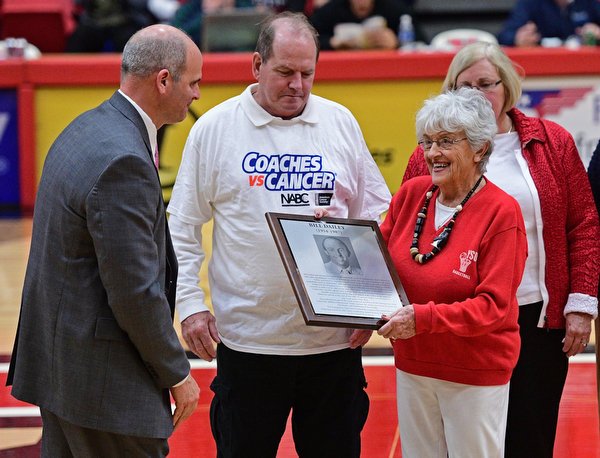 YOUNGSTOWN, OHIO - NOVEMBER 12, 2016: Nancy Dailey, the mother of former YSU men's basketball coach Bill Dailey, is presented with a plaque by YSU AD Ron Strollo at halftime of Saturday nights game. DAVID DERMER | THE VINDICATOR