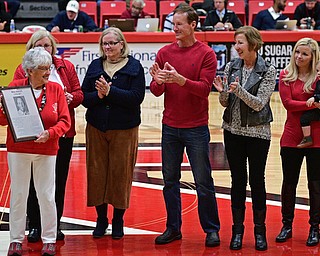 YOUNGSTOWN, OHIO - NOVEMBER 12, 2016: Nancy Dailey, the mother of for YSU men's basketball coach Bill Dailey, smiles while standing on the court with the extended family of former YSU men's basketball coach Bill Dailey, at halftime of Saturday nights game. DAVID DERMER | THE VINDICATOR