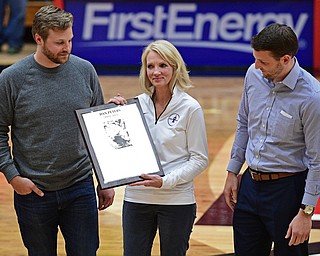 YOUNGSTOWN, OHIO - NOVEMBER 12, 2016: Nancy Peters holds a plaque in honor her husband and former YSU men;s basketball coach Dan Peters while standing with their sons Danny, right, and Michael, left, at halftime of Saturday nights game. DAVID DERMER | THE VINDICATOR
