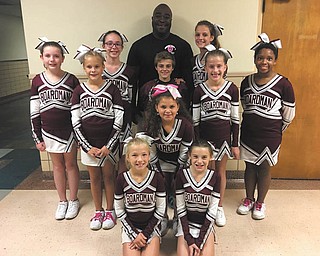 SPECIAL TO THE VINDICATOR
Officer G. Wallace of the Youngstown Police Department stands with Boardman Little Spartans cheerleaders who sold the most YPD 2016 breast cancer shirts. This year, YPD donated more than $3,300 to Youngstown State University Pink Ribbon Cheer Classic by selling 685 shirts. In three years, YPD has donated $5,800 to the cheer classic.