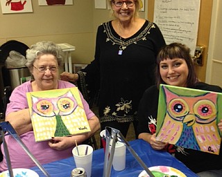 Neighbors | Alexis Bartolomucci.Susan Jacobs stood with a resident and her granddaughter after the finished their owl paintings during the Paint and Taste event at Beeghly Oaks on Oct. 14.