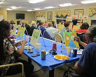Neighbors | Alexis Bartolomucci.Residents, faculty and family members at Beeghly Oaks followed the instructions from Susan Jacobs during the Paint and Taste event on Oct. 14.