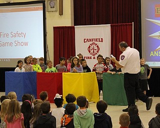 Neighbors | Abby Slanker.Cardinal Joint Fire District Deputy Chief Matt Rarick (right) asked second-grade Hilltop Elementary School students questions during a Fire Safety Quiz Show as a part of Fire Safety Week on Oct. 12.