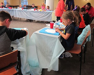 Neighbors | Alexis Bartolomucci.Children worked on outline the owl onto their canvas to get ready to paint during the Halloween Painting Party on Oct. 13 at the Poland library.