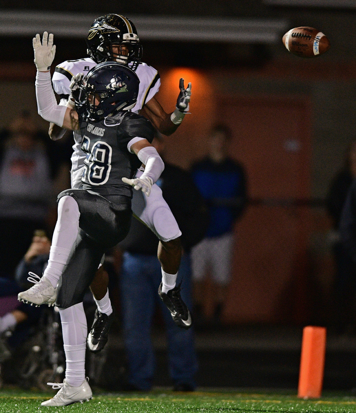 TWINSBURG, OHIO - NOVEMBER 18, 2016: Dakota Shelton #5 of Harding watches the football fall to the ground after it was deflected by Cole Miller #28 of Hudson on the final Harding play on 4th down in the fourth quarter of their playoff game Friday night at Twinsburg High School. Hudson won 24-21. DAVID DERMER | THE VINDICATOR