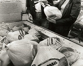 November 26, 1986 -- Shopping and saving top list of pre-Thanksgiving tasks..Turkey decision: Marie Horvatt, left, and Jeanne Serrecchio, both of Austintown, carefully select a Butterball turkey to pop into the oven for todayÕs Thanksgiving dinner. (The Vindicator/ Bob DeMay).