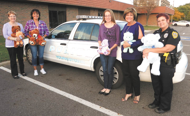 SPECIAL TO THE VINDICATOR
Greater Federation of Women’s Clubs Ohio Austintown Junior Women’s League donated more than 70 stuffed animals to the Youngstown Police Department. Officer Shawna-Cie Ott accepted the donation on behalf of the YPD’s Community Policing program. The animals will be used as “comfort bears” for children during an intervention or crisis. Above, from left, are Janice Simmerman, Ruty Rodriguez-Patterson, Jessica Munger, AJWL President Kathy Rusback and YPD Officer Ott. Information and photos of the AJWL can be found online at www.facebook.com/AJWL2014.