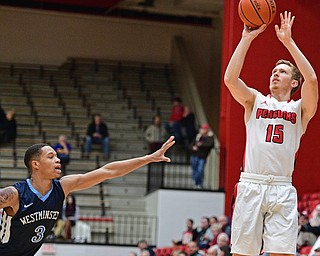 YOUNGSTOWN, OHIO - NOVEMBER 22, 2016: Brett Frantz #15 of YSU shoots over Austin Armwood #3 of Westminster during the first half of their game Tuesday night at the Beeghly Center. DAVID DERMER | THE VINDICATOR