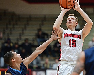 YOUNGSTOWN, OHIO - NOVEMBER 22, 2016: Brett Frantz #15 of YSU shoots over Austin Armwood #3 of Westminster during the first half of their game Tuesday night at the Beeghly Center. DAVID DERMER | THE VINDICATOR