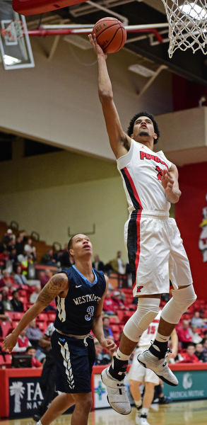 YOUNGSTOWN, OHIO - NOVEMBER 22, 2016: Devin Haygood #2 of YSU goes to the basket around Austin Armwood #3 of Westminster during the first half of their game Tuesday night at the Beeghly Center. DAVID DERMER | THE VINDICATOR