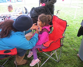 Neighbors | Alexis Bartolomucci.One of the children at the Junk in Your Trunk sale got her face painted by a Fitch high school student on Oct. 22.