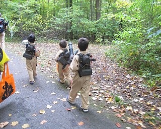 Neighbors | Alexis  Bartolomucci.Three young boys dressed up as ghost busters shooting different things in the woods during the Boo thru the Woods event at Boardman Park on Oct. 16.