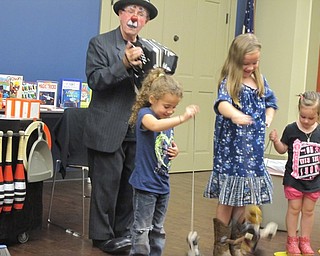 Neighbors | Alexis Bartolomucci.Jocko the Clown brought up members from the audience to help him make his puppets dance while he played music during his show on Oct. 18 at the Boardman library.