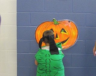 Neighbors | Alexis Bartolomucci.One of the children played Pin the Nose on the Pumpkin at the Halloween Carnival on Oct. 29 at McKinley Elementary.