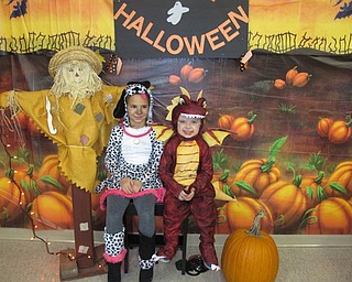 Neighbors | Alexis Bartolomucci.Catherine and Jeffrey dressed up in Halloween costumes and posed by the Halloween decorations at the Halloween Carnival on Oct. 29 at McKinley Elementary.