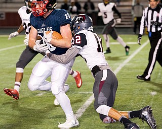 MICHAEL G TAYLOR | THE VINDICATOR- 11-26-16- 4th qtr, JFK's #20 Isaac Hadley drags Canal Preps' #12 Savon Mitchell on his way to a 7 yard gain. OHSAA D7 Football Semi  John F Kennedy Eagles vs Canal Winchester Harvest Prep Warriors at Woody Hayes Quaker Stadium in New Philadelphia, OH