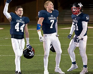 MICHAEL G TAYLOR | THE VINDICATOR- 11-26-16- JFK's #44  Jacob Coates, #7 Evan Boyd and #51 Phillip Sajnovsky celebrates their victory. OHSAA D7 Football Semi  John F Kennedy Eagles vs Canal Winchester Harvest Prep Warriors at Woody Hayes Quaker Stadium in New Philadelphia, OH.
