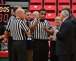 YOUNGSTOWN, OHIO - NOVEMBER 26, 2016: The officials apeakt o Head coaches Jerry Slocum of YSU and Reggie Witherspoon of Canisius discussing the use of a temporary shot clock after a malfunction to the regular shot clocks before their game Saturday afternoon at the Beeghly Center. DAVID DERMER | THE VINDICATOR