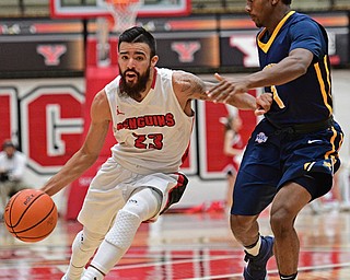 YOUNGSTOWN, OHIO - NOVEMBER 26, 2016: Francisco Santiago #23 of YSU drives on Malik Johnson #1 of Canisius during the first half of their game Saturday afternoon at the Beeghly Center. DAVID DERMER | THE VINDICATOR