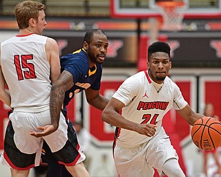 YOUNGSTOWN, OHIO - NOVEMBER 26, 2016: Cameron Morse #24 of YSU drives to the basket while teammate Brett Frantz #15 blocks Martin Dixon-Green #3 of Canisius during the first half of their game Saturday afternoon at the Beeghly Center. DAVID DERMER | THE VINDICATOR