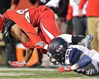 YOUNGSTOWN, OHIO - NOVEMBER 26, 2016: Jody Webb #20 of YSU is brought down by the jersey by Carter McManes #46 of Samford during the first half of their playoff game Saturday evening at Stambaugh Stadium. Youngstown State won 38-24. DAVID DERMER | THE VINDICATOR
