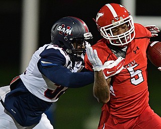YOUNGSTOWN, OHIO - NOVEMBER 26, 2016: Alvin Bailey #5 of YSU runs with the ball while being tackled by Darius Harvey #32 of Samford during the first half of their playoff game Saturday evening at Stambaugh Stadium. Youngstown State won 38-24. DAVID DERMER | THE VINDICATOR