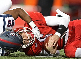 YOUNGSTOWN, OHIO - NOVEMBER 26, 2016: Hunter Wells #6 of YSU is sacked by Ahmad Gooden #99 of Samford during the first half of their playoff game Saturday evening at Stambaugh Stadium. Youngstown State won 38-24. DAVID DERMER | THE VINDICATOR