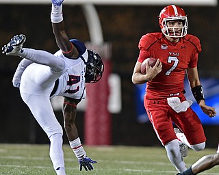 YOUNGSTOWN, OHIO - NOVEMBER 26, 2016: Nathan Mays #7 of YSU runs the football while Sam Pittway #41 of Samford flied through the air after being blocked during the first half of their playoff game Saturday evening at Stambaugh Stadium. Youngstown State won 38-24. DAVID DERMER | THE VINDICATOR