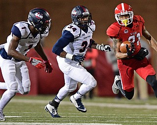 YOUNGSTOWN, OHIO - NOVEMBER 26, 2016: Darien Townsend #21 of YSU runs with the ball while being chased by Marquis McCullum #1 and Aaron Harris #34 of Samford during the first half of their playoff game Saturday evening at Stambaugh Stadium. Youngstown State won 38-24. DAVID DERMER | THE VINDICATOR