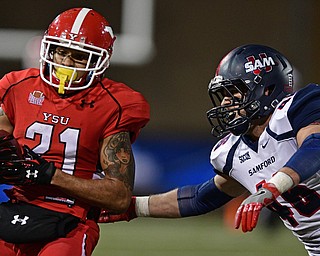 YOUNGSTOWN, OHIO - NOVEMBER 26, 2016: Darien Townsend #21 of YSU runs the ball before being hit out of bounds by Carter McManes #46 of Samford during the second half of their playoff game Saturday evening at Stambaugh Stadium. Youngstown State won 38-24. DAVID DERMER | THE VINDICATOR