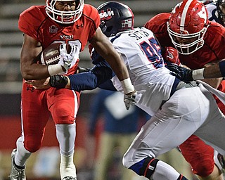 YOUNGSTOWN, OHIO - NOVEMBER 26, 2016: Tevin McCaster #37 of YSU runs the ball while being tackled by Mitchell Smith #96 of YSU during the second half of their playoff game Saturday evening at Stambaugh Stadium. Youngstown State won 38-24. DAVID DERMER | THE VINDICATOR