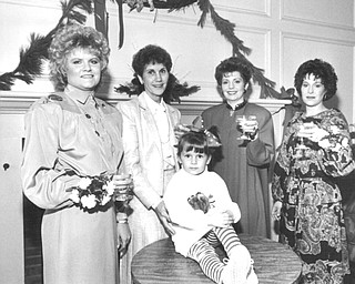 12041987 Warren Junior Women's League Champagne Luncheon Margo Hiller, a modelsitting on table, and from left, Valerie Burke, Barbara Anderson, Nancy Merio and susan Burkey.