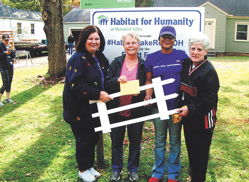 Mahoning Retired Teachers Association recently helped to prepare a house with Habitat for Humanity on Lake Road in Austintown. The group provided the workers with lunch and assisted on the project. Among the volunteers were Youngstown State University honors college students, Sisters in Christ, Habitat of Mahoning Valley and Tamesha Elliott, the new home owner. She will reside in the home with her daughter and mother. From left, are Peggy Bennett, June Logan, Elliott and Mary Ann Tavolario. SPECIAL TO THE VINDICATOR